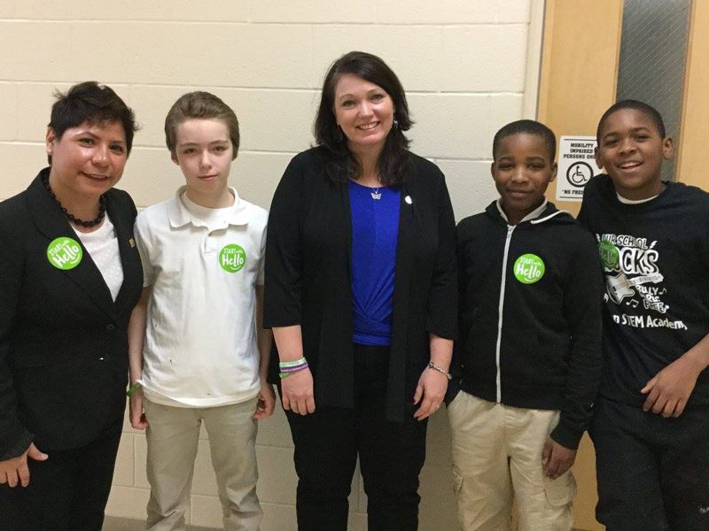 Nicole Hockley with an educator and students wearing Start With Hello stickers.