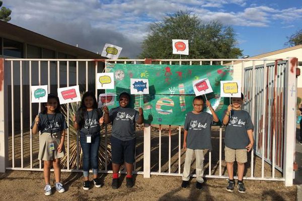 Elementary school students holding Start With Hello Week signs