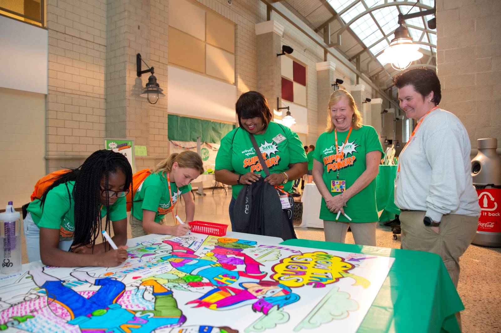 Students participating in the National SAVE Promise Club Youth Summit in 2019 write multi-colored messages of kindness to their peers.