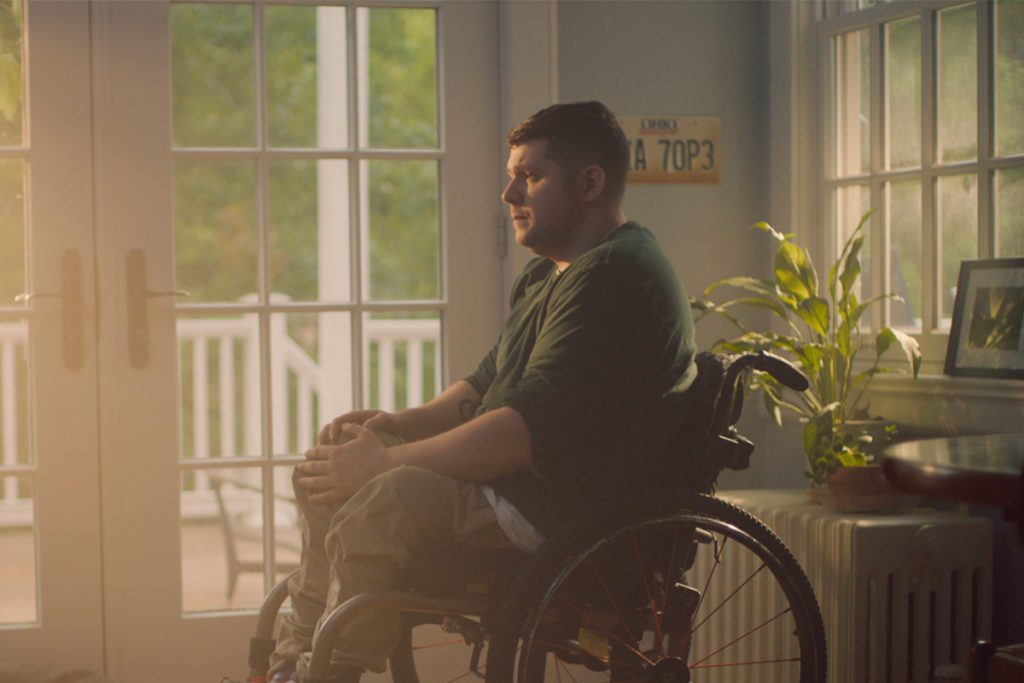 Nick Walczak from Chardon, Ohio sits in a wheelchair by a window. In 2012, he was shot three times. Paralyzed from waist down.