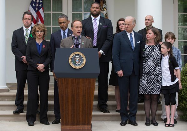 In this photo taken April 17, 2013, President Barack Obama listens gri- faced, to Mark Barden, who lost his son Daniel in the Newton shootings, speak about measures to reduce gun violence during a White House Rose Garden news conference after the U.S. Senate rejected background checks and other administrations including a new assault weapons ban. "I see this as just round one," the president declared, raw emotion in his voice. "Sooner or later, we are going to get this right." Rep. Gabby Giffords, second from left, Vice President Joe Biden, and Newtown family members from left, Neil Heslin, father of Jesse Lewis; Jimmy Greene, father of Ana; Nicole Hockley, mother of Dylan; Mark Barden's wife Jackie Barden, with their children Natalie and James; and Jeremy Richman, father of Avielle, behind the Barden's.
